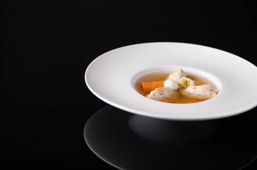 soup with meat in the test on a black background
