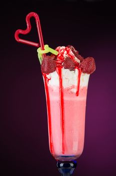 fruit cocktail ice cream with straw on red background, isolated. summer tropical smoothie