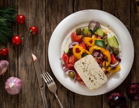 salad vegetables and cheese on wooden background, view from the top