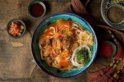 oriental dishes on decorative old tiles. noodles and spices with braid on decorative old paving stones