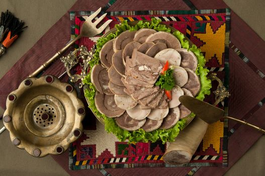 oriental dish of boiled meat and dough on a tablecloth