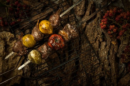 pieces of fried meat with lemon on a background of tree bark