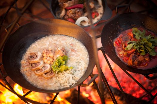 cook a meat dish with peas at the stake with spruce branches