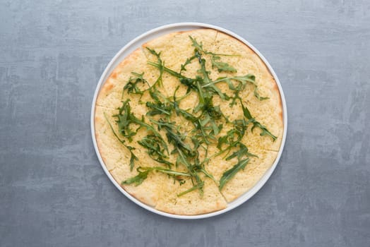 pancakes with greens in a plate on a gray background