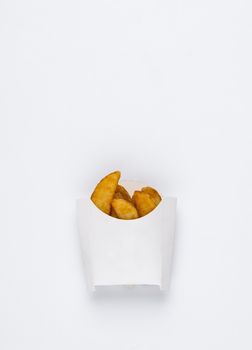 slices of fried potatoes in a white box on a white background. studio photo of fried french fries on white background