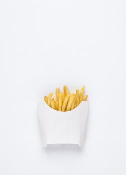 on a white background fried french fries in a white box. studio photo of fried french fries on white background