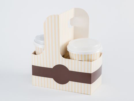 paper cups with coffee in a takeaway box on a white background