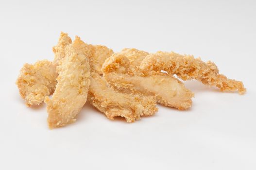 chicken pieces in bread crumbs close up on a white background