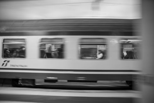 teni,italy may 28 2020 :panning trains at the station in speed with people inside