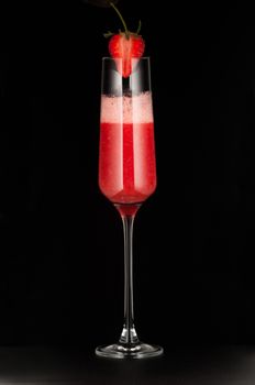 one glass cup with strawberry drink and strawberries on dark background