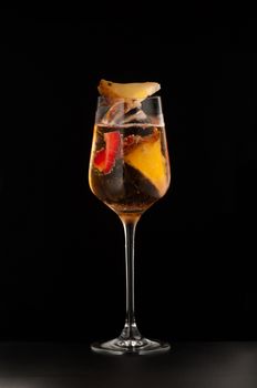 one glass beaker with a fruity drink on a dark background