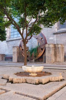 Old fountain in the courtyard of the Cathedral of Saint Mary of the See in Seville, Spain
