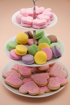 pink cookies in the shape of hearts and colorful round cookies in the candy on Valentine's Day