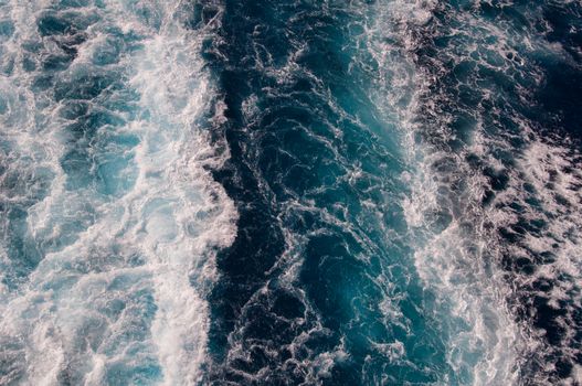 white and blue wave crests in a cruise ships wake, taken in the North Atlantic