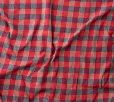 red checkered fabric for sewing various clothes with waves, full frame