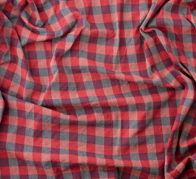 red checkered fabric for sewing various clothes with waves, full frame