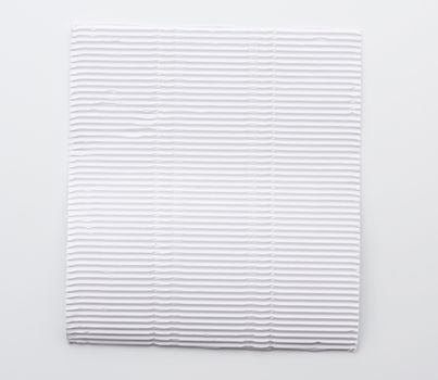 white blank corrugated paper sheet on white background , close up