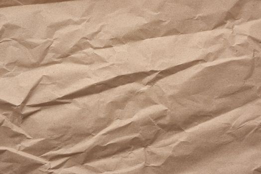 fragment of crumpled blank sheet of brown wrapping kraft paper, vintage texture for the designer, full frame