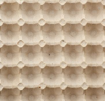volumetric texture of a beige paper egg tray, full frame, close up