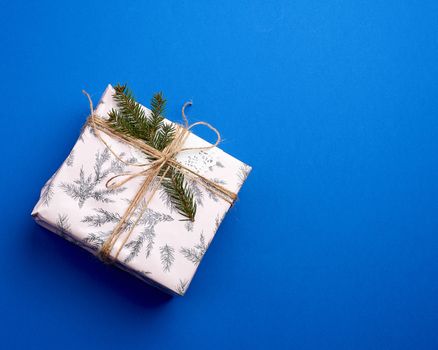 pink wrapped gift boxes and tied with a brown rope, dark blue holiday backdrop