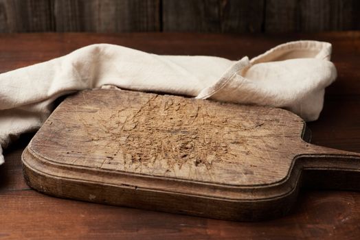 empty brown very old vintage kitchen cutting board with handle, place for an inscription