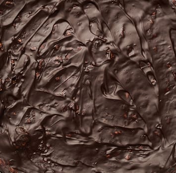 texture of baked brownie chocolate cake with chocolate poured. Cooked homemade food. Chocolate pastry. Sweet meal, homemade dessert.