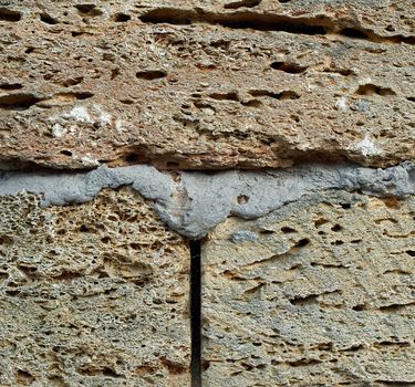 brick wall of large stone blocks fastened with gray cement, copy space