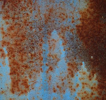 brown iron texture of rusty sheet with remains of blue paint. Metal rusty texture background rust steel. Full frame