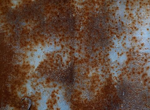 iron texture of rusty sheet with remains of blue paint. Metal rusty texture background rust steel.