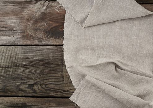 Gray linen napkin kitchen wooden background in vintage style, copy space
