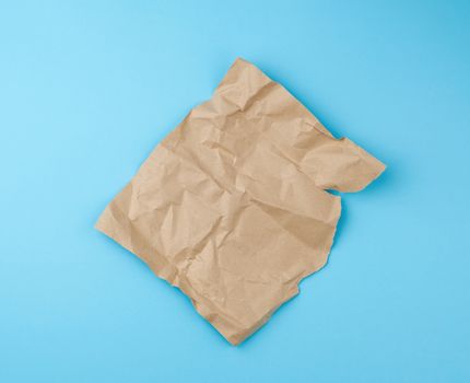 sheet of brown craft paper for packaging on a blue background, close up