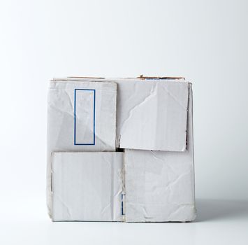 white crumpled cardboard box with a closed lid on a white background. Blank cardboard storage box. Warehouse storage. Freight shipping, delivery. Carton case.