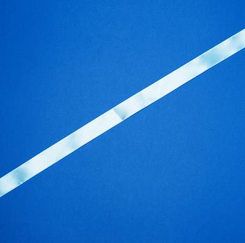 light blue ribbon on a dark blue background, abstract backdrop