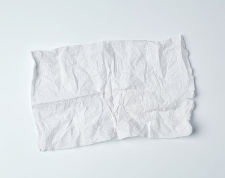 crumpled torn soft white sheet of paper towel with curled corners on a white background