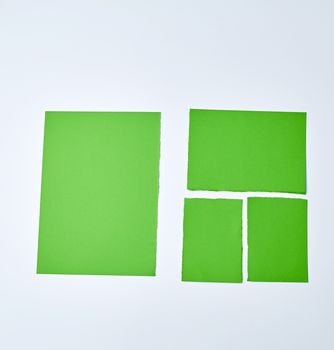 various blank pieces of green paper on white background, copy space. Collection paper rip.