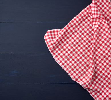 white red checkered kitchen towel on a blue wooden background, picnic background, copy space