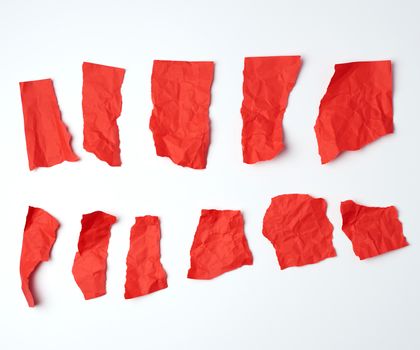 various crumpled blank pieces of red paper on white background, copy space