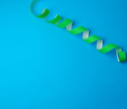 untwisted reel with green sticky stickers on a blue background, top view