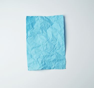 empty crumpled blue rectangular sheet of paper on a white background, copy space