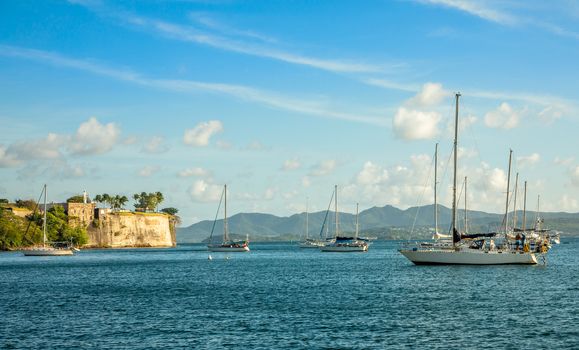 Yachts anchored in Fort De France harbor with fortress in the background, Fort-De-France, Martinique,  French overseas department