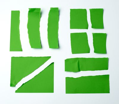 various blank pieces of green paper on white background, copy space