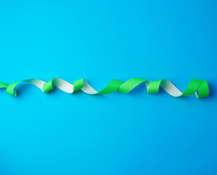 untwisted reel with green sticky stickers on a blue background, top view