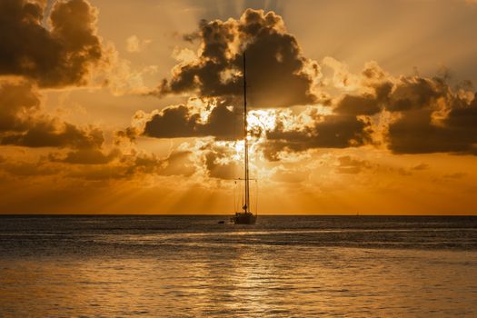 Sunset view of yacht anchored in the lagoon, Britannia bay, Mustique island, Saint Vincent and the Grenadines, Caribbean sea