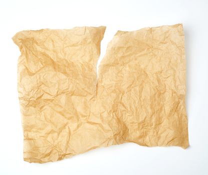torn piece of brown piece of parchment paper on white background