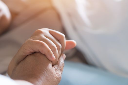 Loving couple holding hands, Hopeful, care love emotional concept, Together women hold hand lover while Sick Patients with Infusion pump infuses fluid. Encouragement comforting Recovering from family