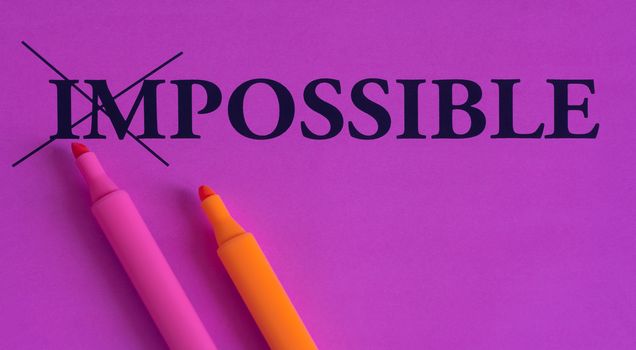 Impossible is possible, words on a bright background, concept, art, change, motivation, purple, pink, orange, marker, highlighter, paper