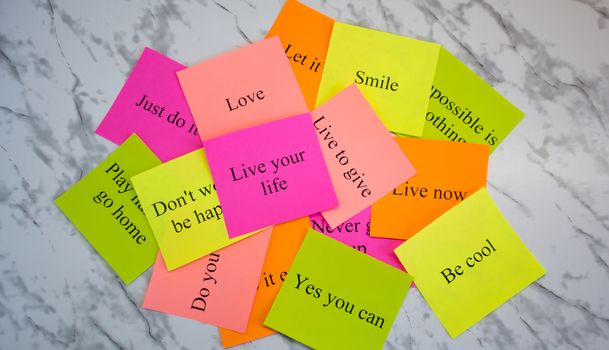 Motivational words on colorful stickers on a marble table. Business plan, strategy, concept, future. Copy space, creativity, project, art. Vision board.