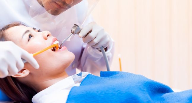 Dentistry and teeth healthcare concept at dental clinic. Dentist check-up teeth for young asian patient.