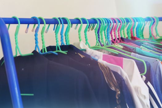 Selective focus of clothes hanging on rack with light effect