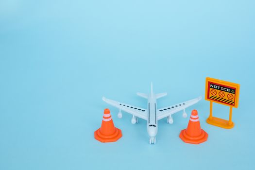 White airplane model with prohibition sign on blue background for vehicle and transportation in coronavirus or Covid-2019 situation concept